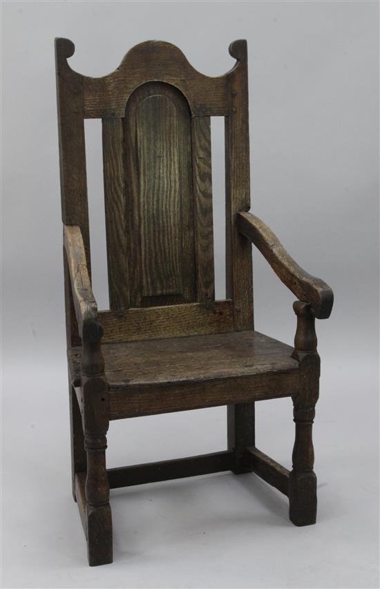 An early 18th century oak wood seat elbow chair,